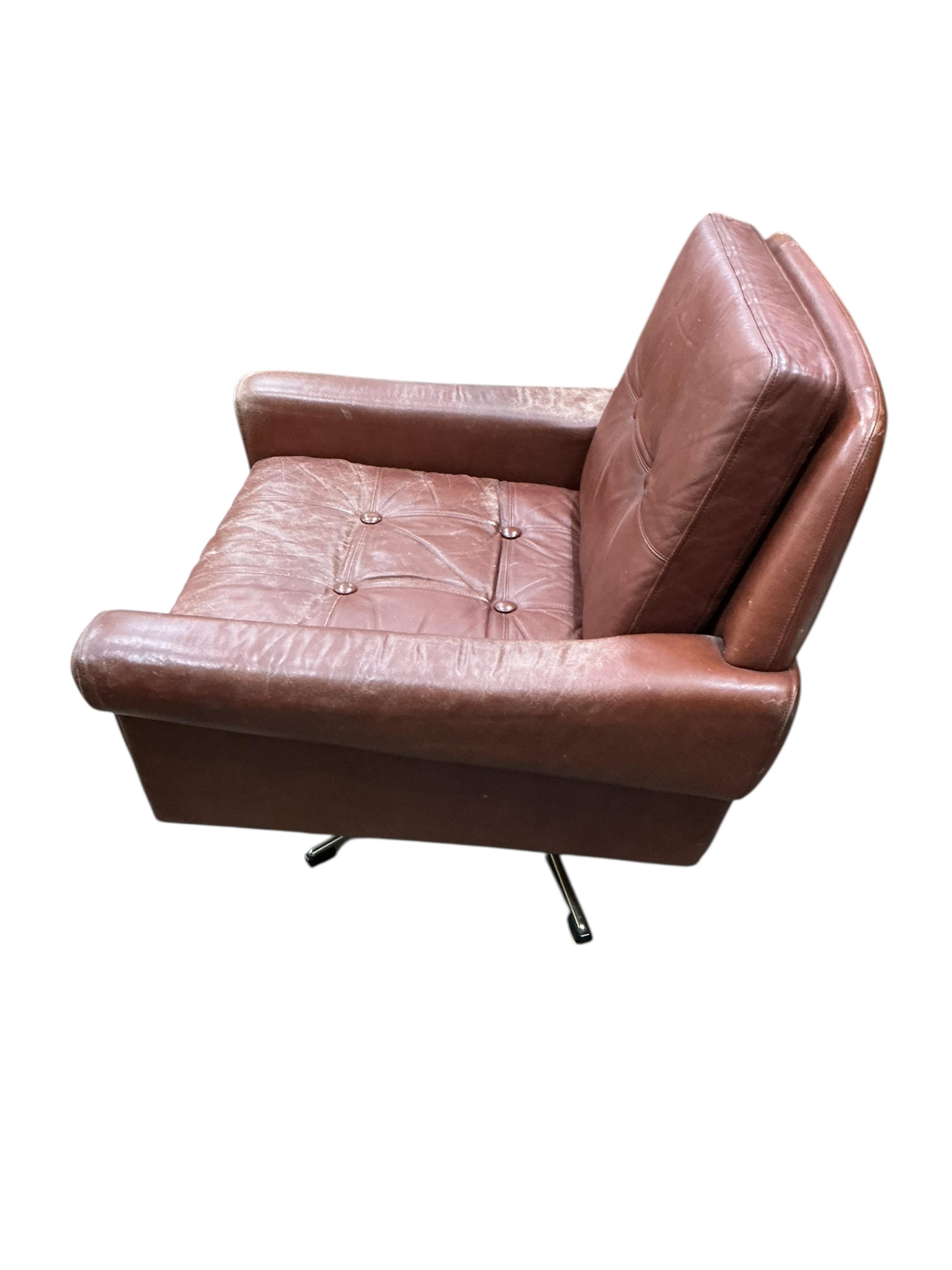A Danish mid century Svend Skipper brown leather swivel lounge chair on five prong chrome base, width 74cm, depth 76cm, height 70cm